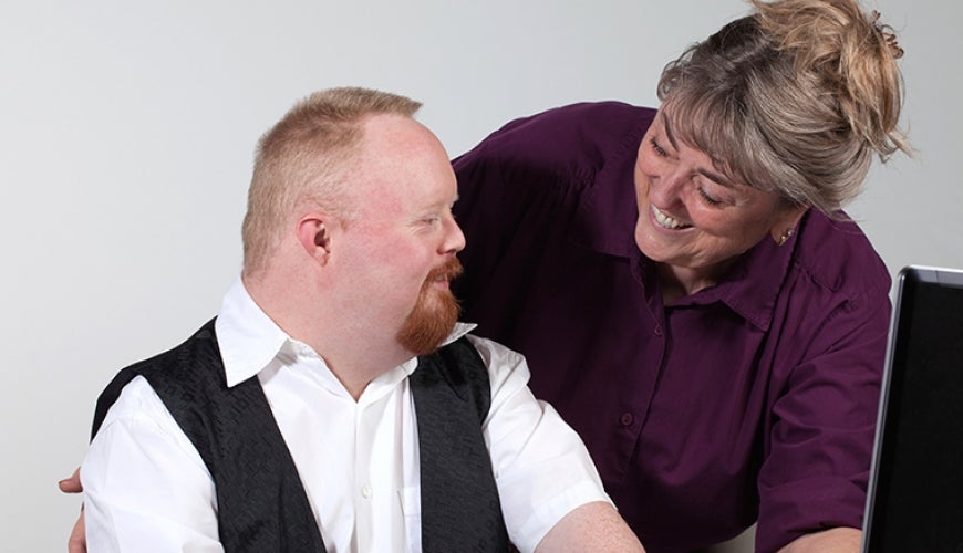 Worker with Down Syndrome and co-worker. Image from iStock.