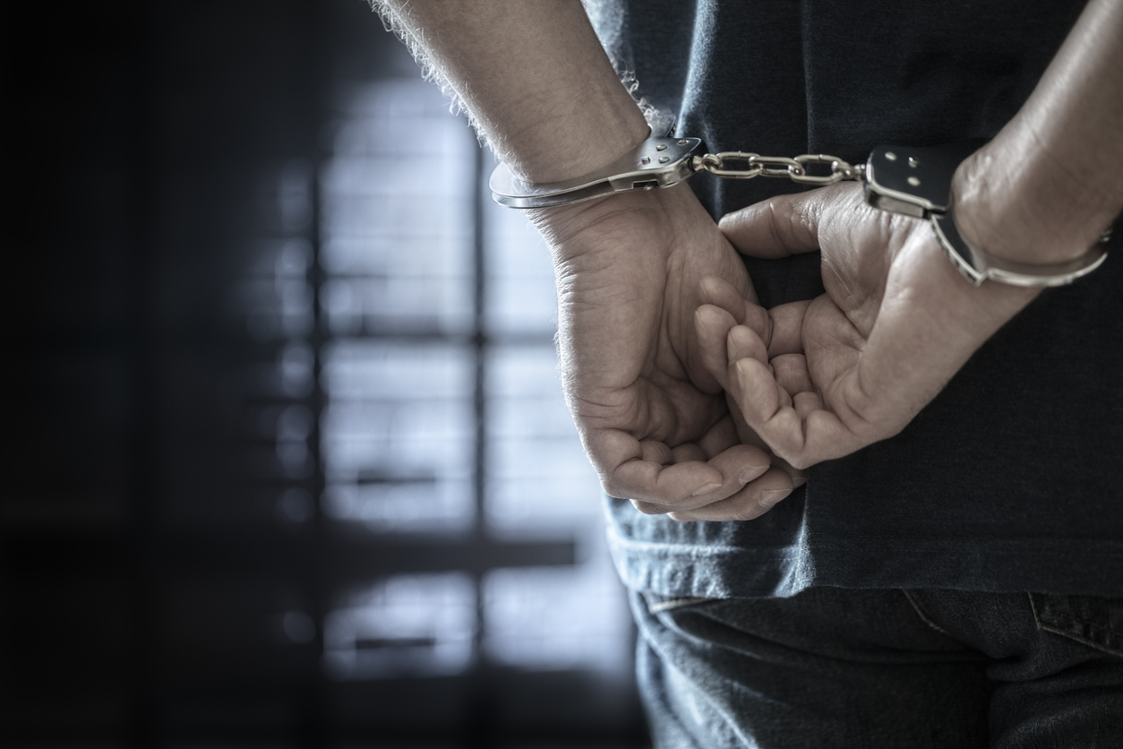 A person's hands in handycuffs
