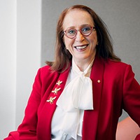 Rosalind Croucher in an office, smiling