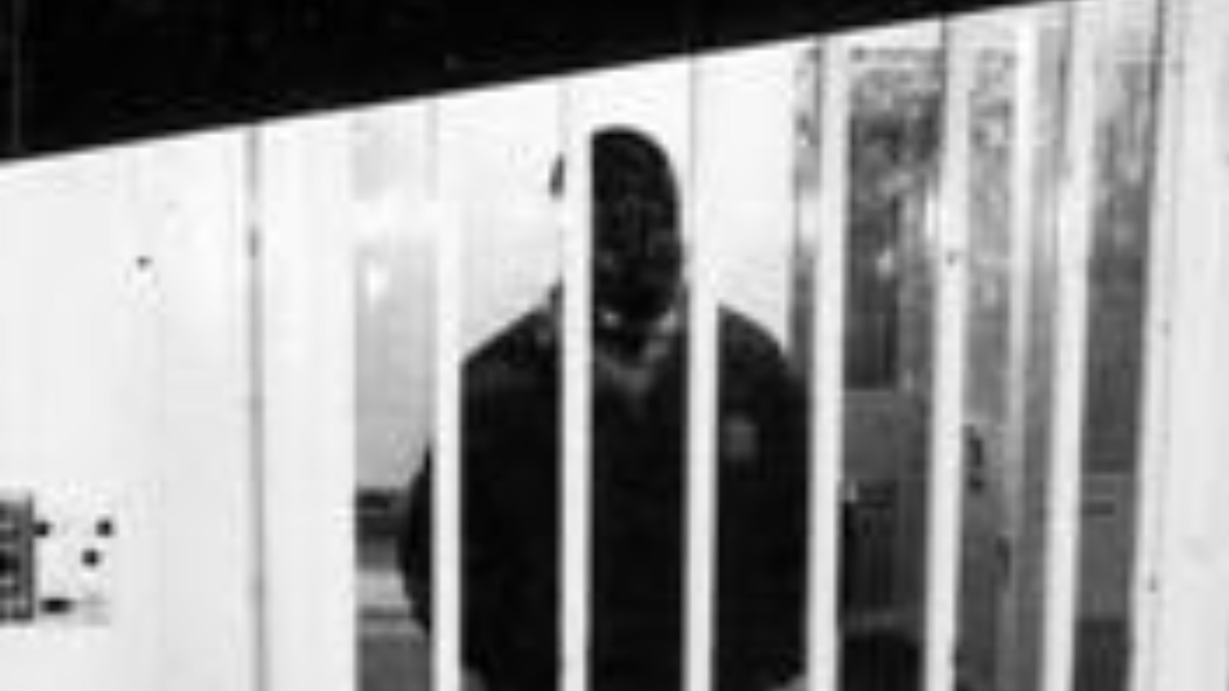 Person in behind bars in jail