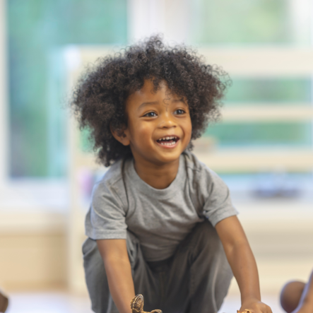 A young Aboriginal child playing with toys
