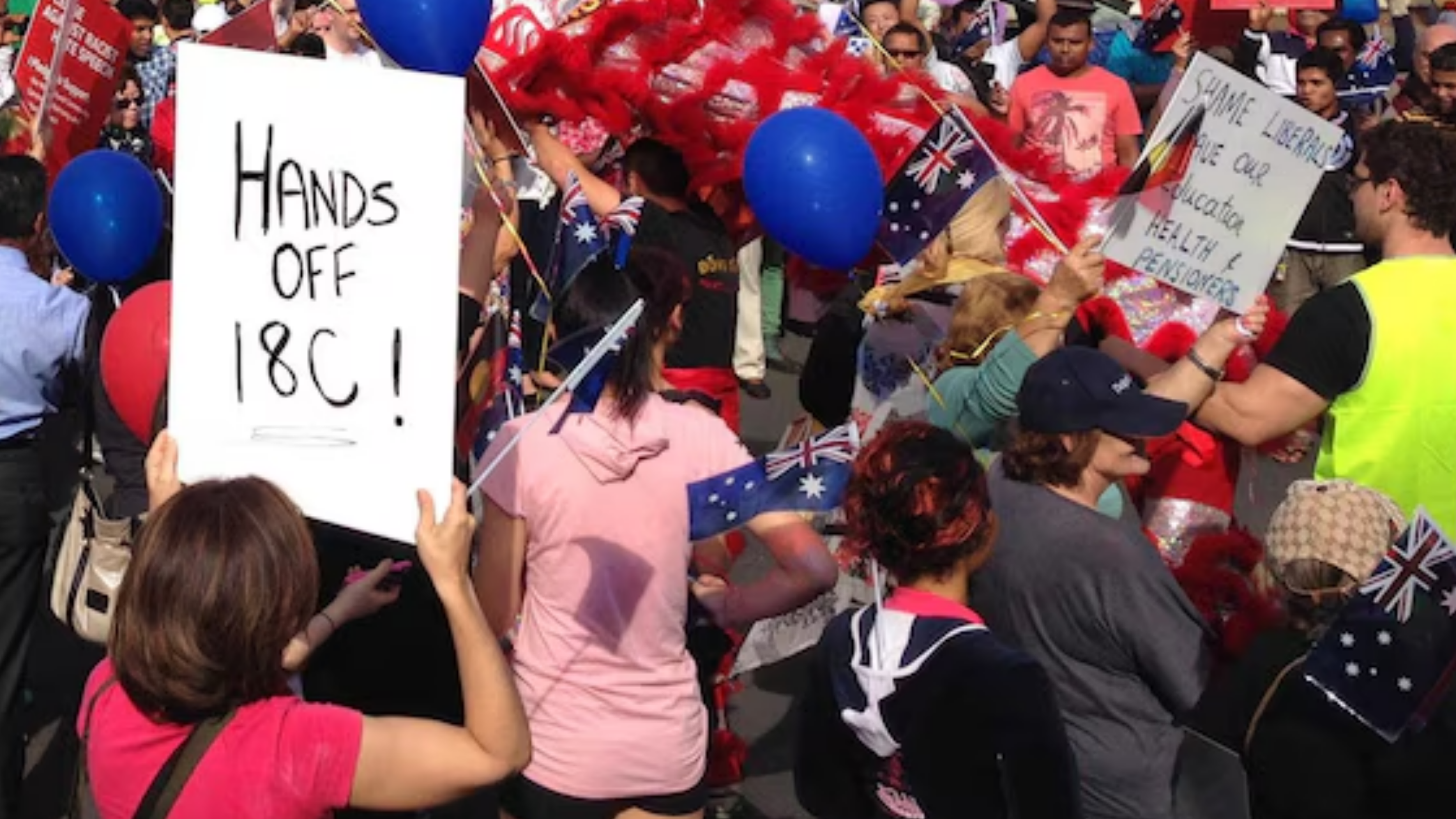 a woman is holding a sign at a protect. the sign reads hands off 18C