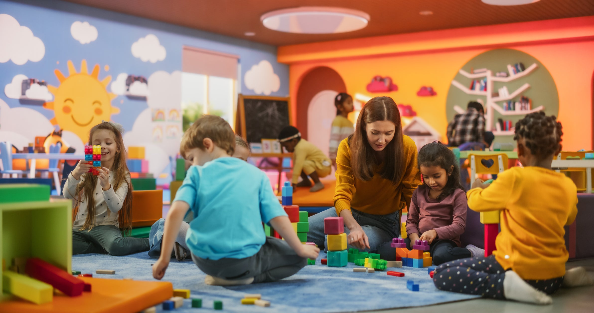 young children and carer playing