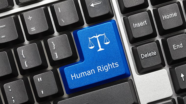 The words 'Human Rights' appear over the enter key on a keyboard