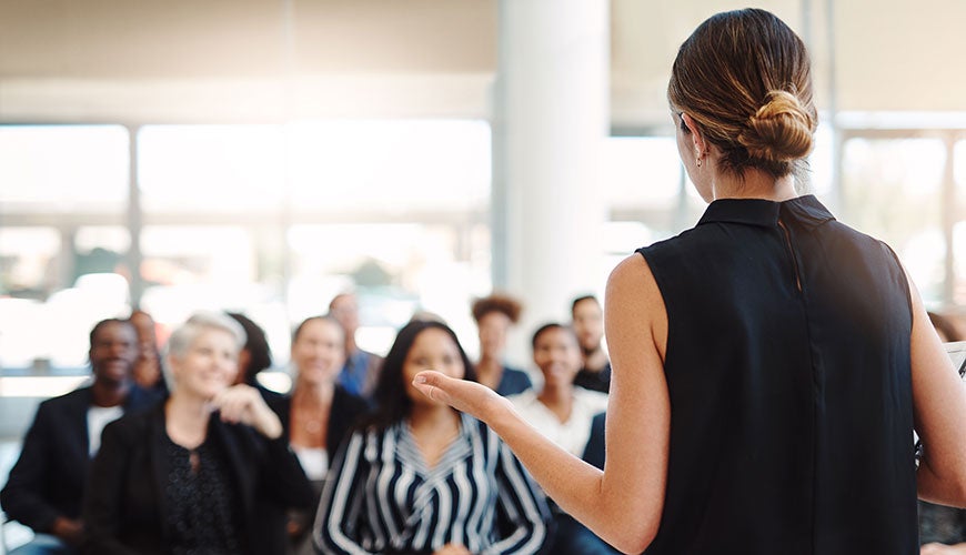 Woman training a business audience