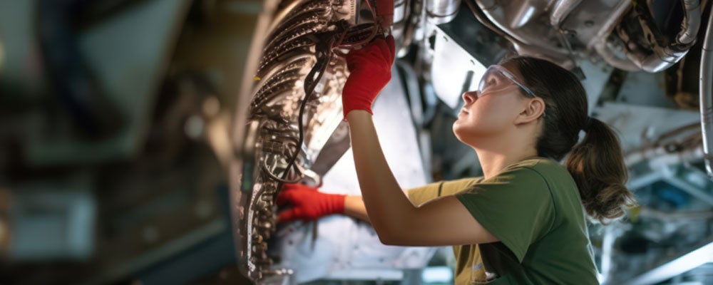 A proud and confident female aerospace engineer works on an aircraft, displaying expertise in technology and electronics. 