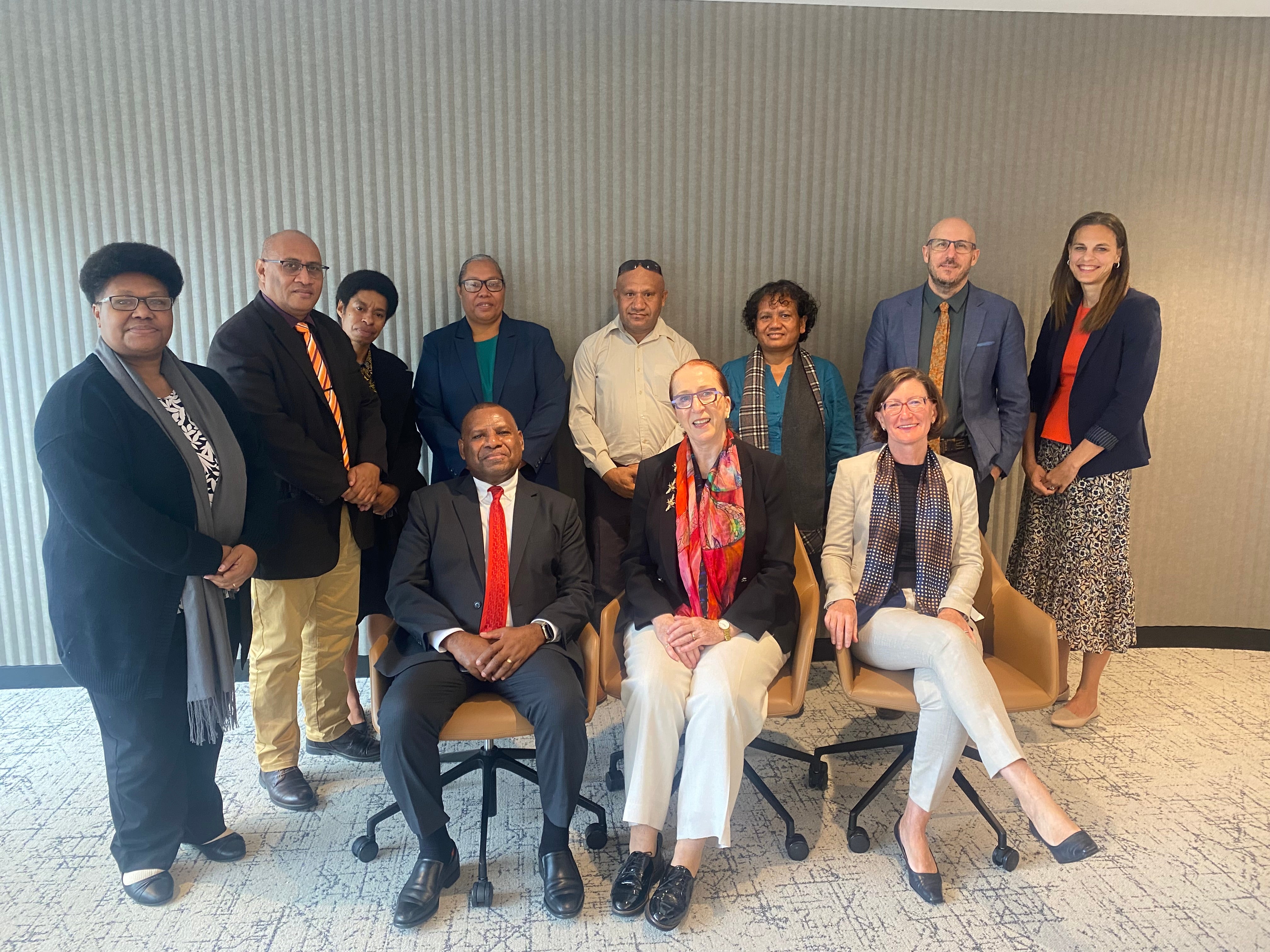 President Emeritus Professor Rosalind Croucher and CEO Leanne Smith sitting with representatives from the PNG Department of Justice and Attorney General