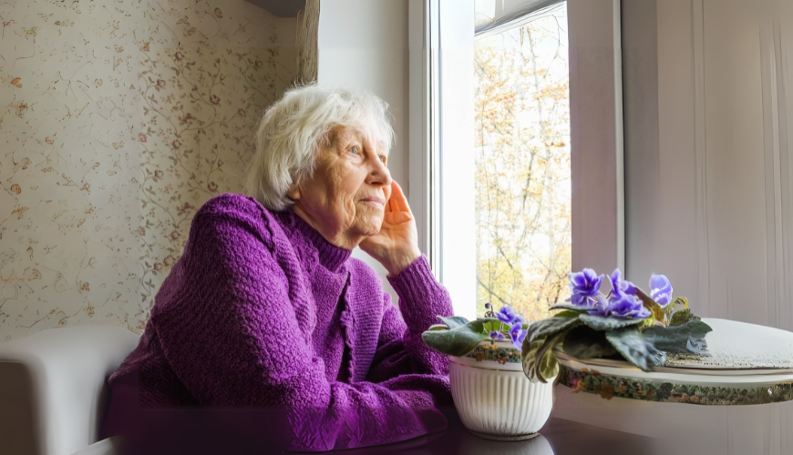 An old person looking out a window