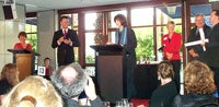 2002 Human Rights Radio Award winners Robyn Ravlich (giving acceptance speech) and Russell Stapleton (far right, holding certificates), accepting their awards for their radio documentary On the Raft, All at Sea.