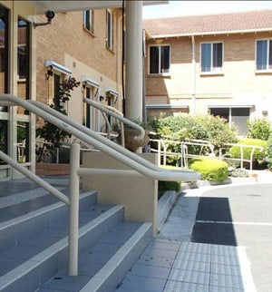 Handrail extended but encroaches on path of travel
