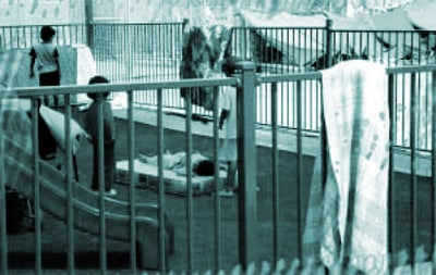 Children in playground at Woomera with hunger strike in background, January 2002