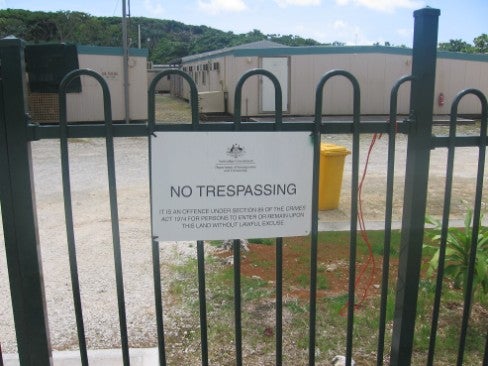 Photo of the construction camp outside the gate with the No Trespassing sign on it