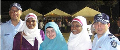 Two policemen and three Muslim women in Australia, at a festival