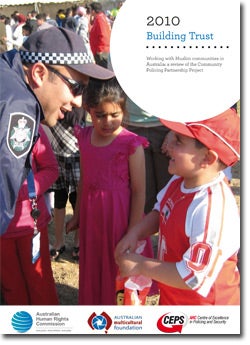  Building Trust publication cover - Policeman talking to boy. Photo (c) AFP