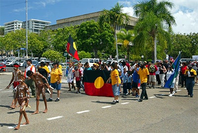 Indigenous people marching down the street