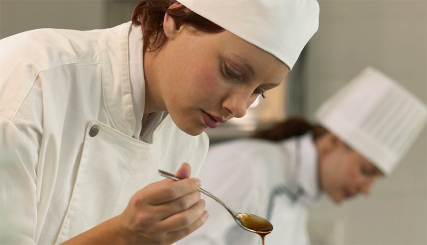 Female chef checking a sauce