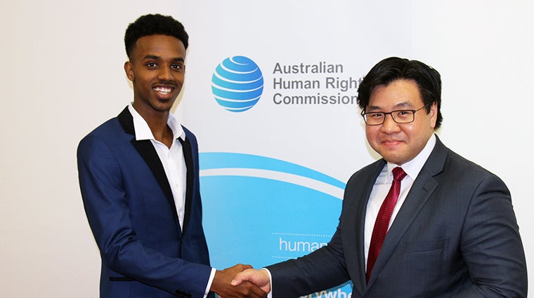 Mohamed Semra winning the 'Racism. It Stops With Me' essay prize, presented by Dr Tim Soutphommasane