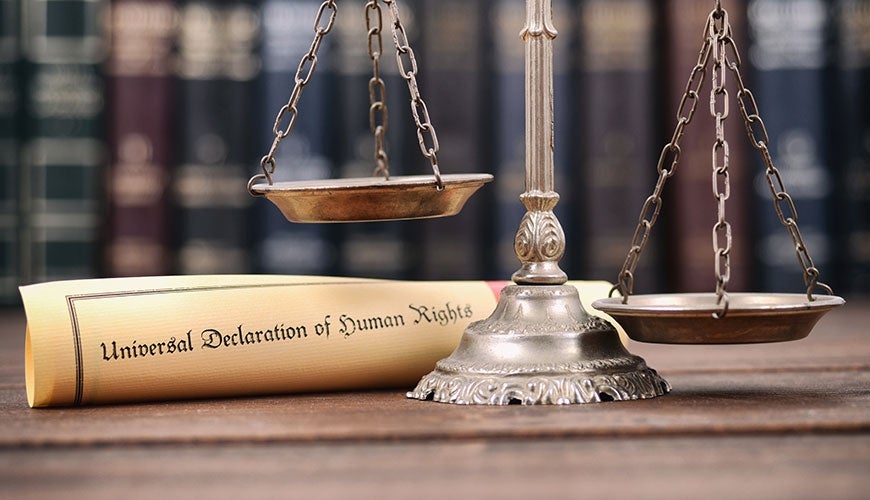 Scales of Justice with parchment scroll of UDHR
