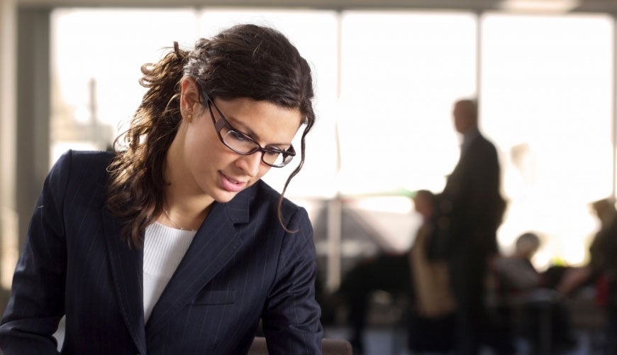 Woman looking down at her work in office setting