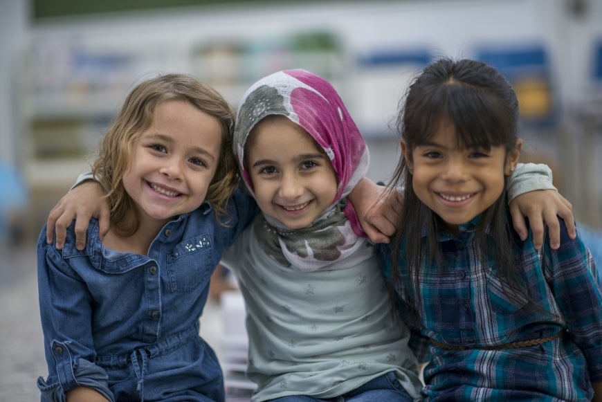 Diverse trio of girls smiling and happy