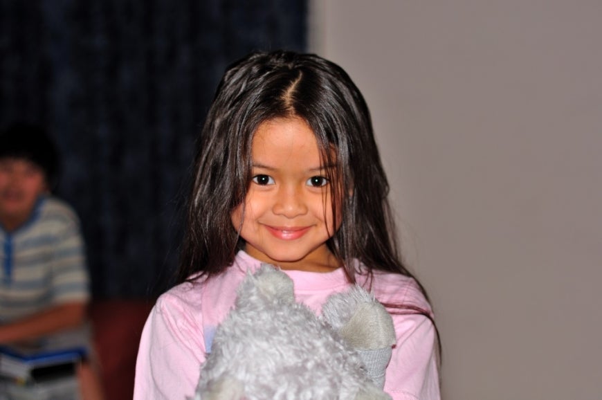 Picture of a young girl holding her doll