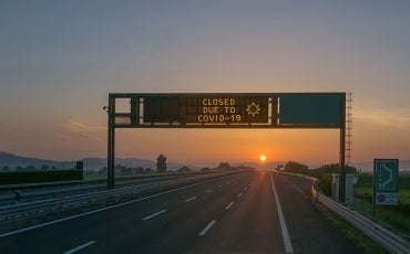 highway with sign 'closed due to Covid'