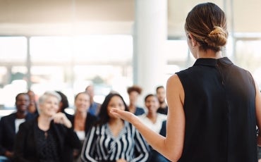 Woman training a business audience