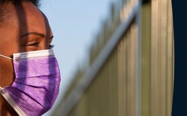 Person in detention centre in covid mask