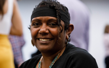 Jasmine Cavanagh at the Human Rights Awards in 2019 wearing a black headband, colourful necklace and black shawl 