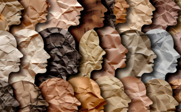 A collage of blank faces made of paper of varying colours and textures