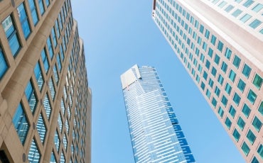 three high rise buildings with blue sky background