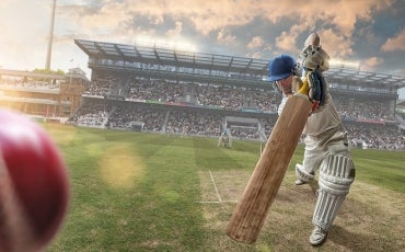 cricketer hitting ball in the stadium