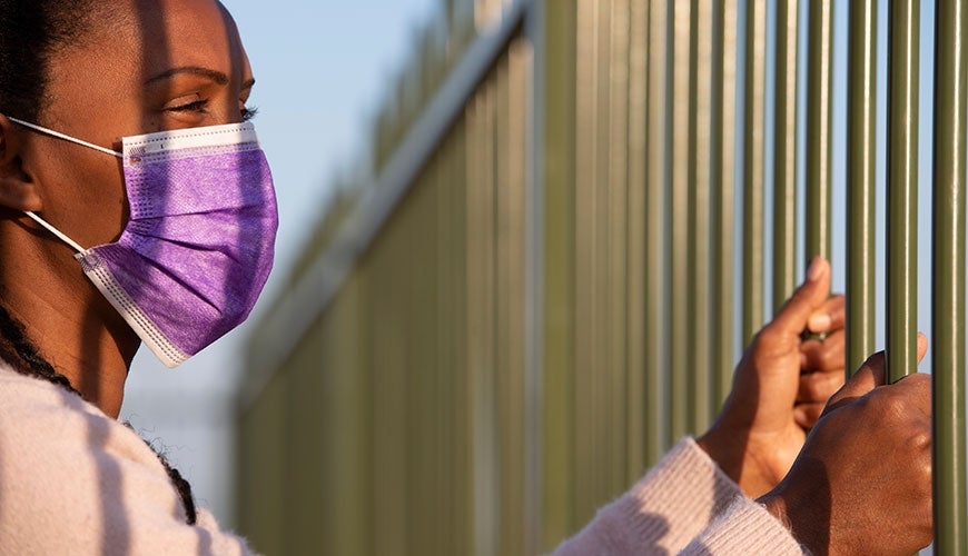 Person in detention centre in covid mask