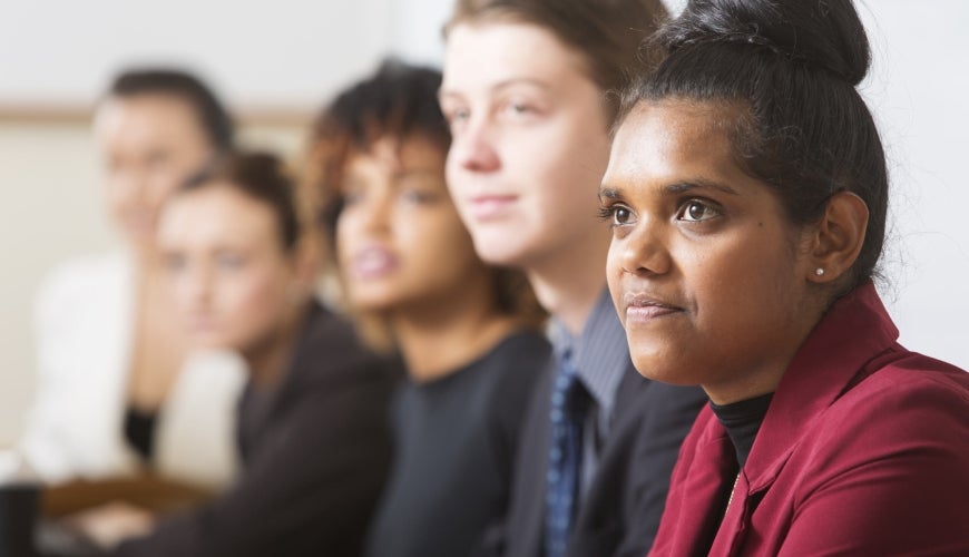 Business meeting with diverse group, focus on young Aboriginal woman