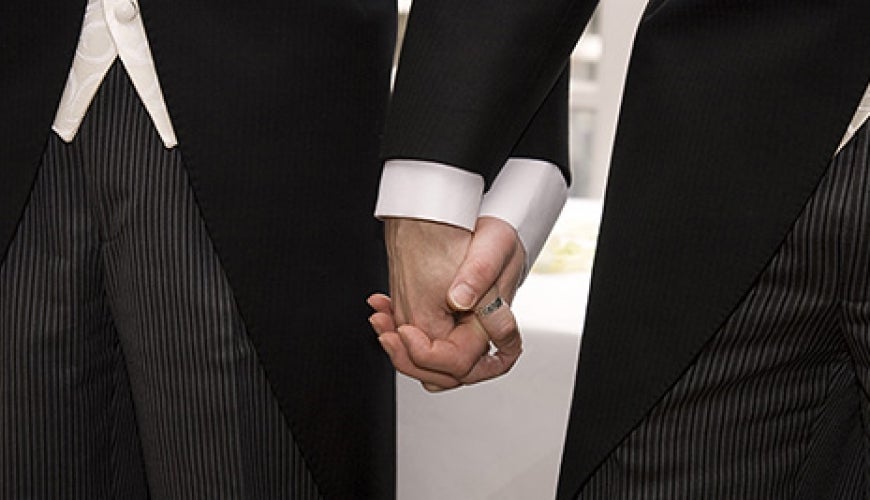 Two men holding hands, getting married