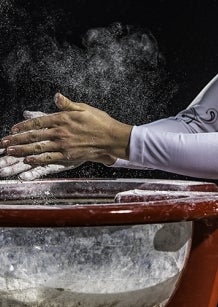 Gymnast applying chalk