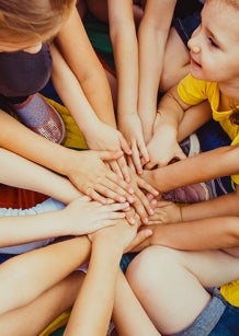 Children in a group holding hands