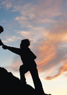 silhouettes of children holding hands at sunset