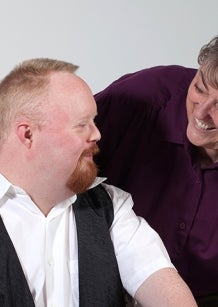 Worker with Down Syndrome and co-worker. Image from iStock.