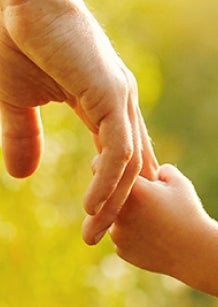 Child holding adults' hand
