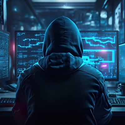 Hacker in front of computer screens